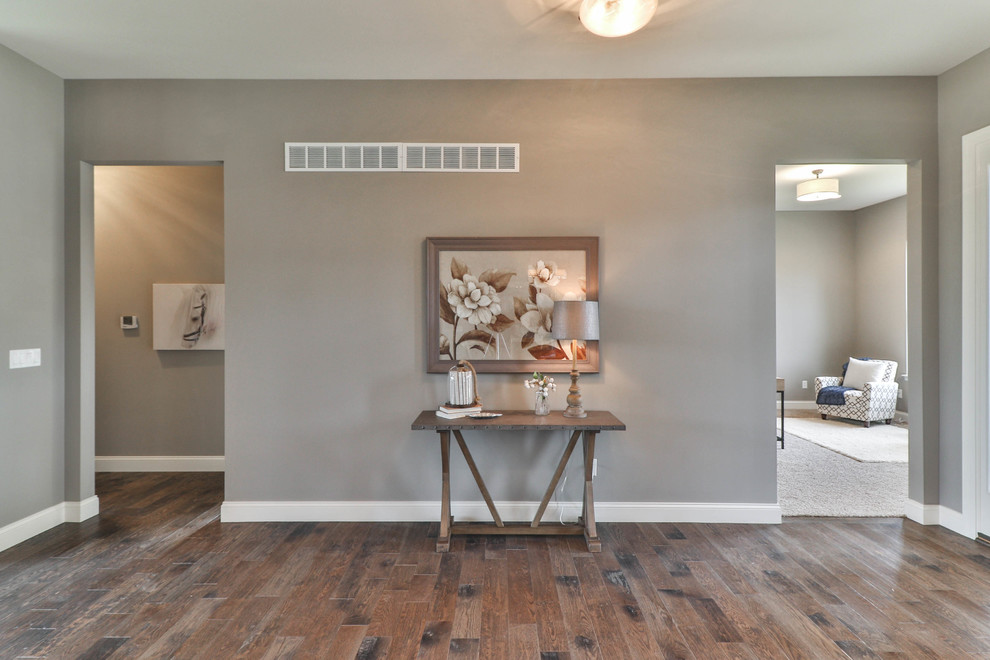 Foyer - mid-sized transitional dark wood floor and brown floor foyer idea in St Louis with gray walls and a white front door