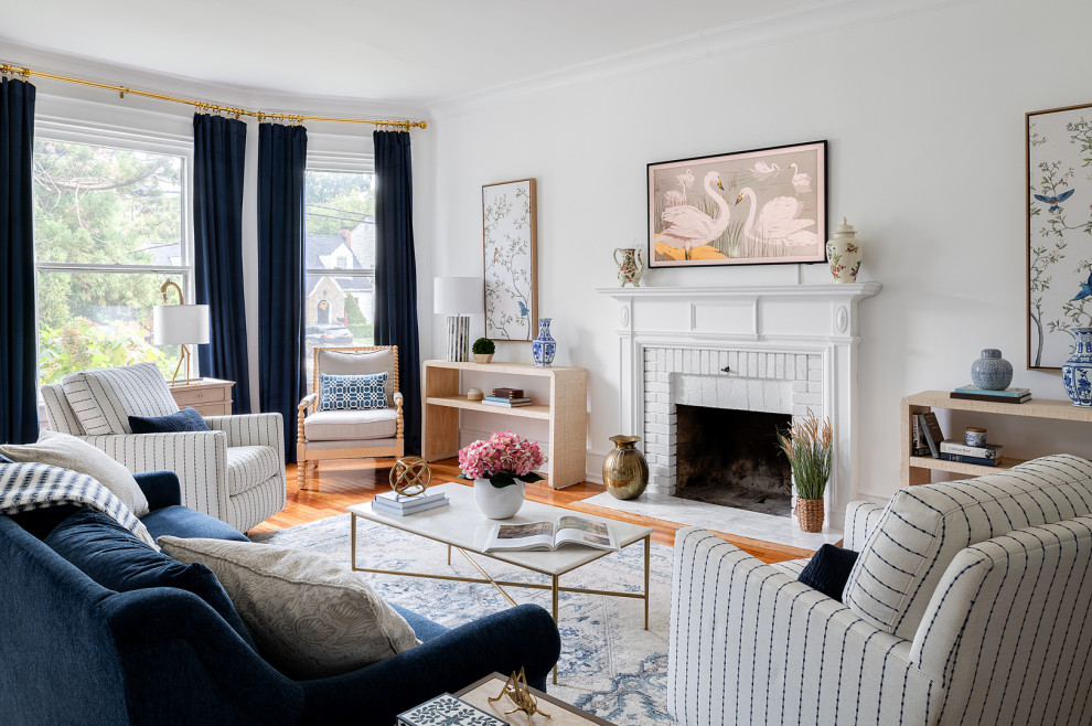 Inspiration for a large transitional formal enclosed living room in Philadelphia with white walls, medium hardwood floors, a standard fireplace, a brick fireplace surround, a wall-mounted tv and brown floor.