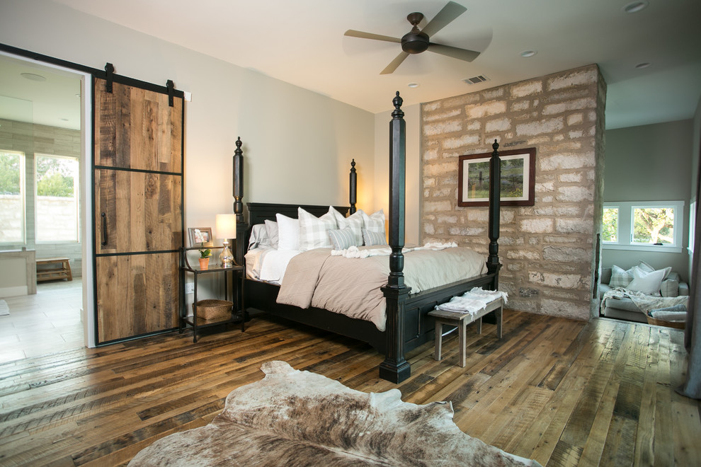 Design ideas for a large country master bedroom in Austin with beige walls, medium hardwood floors and brown floor.