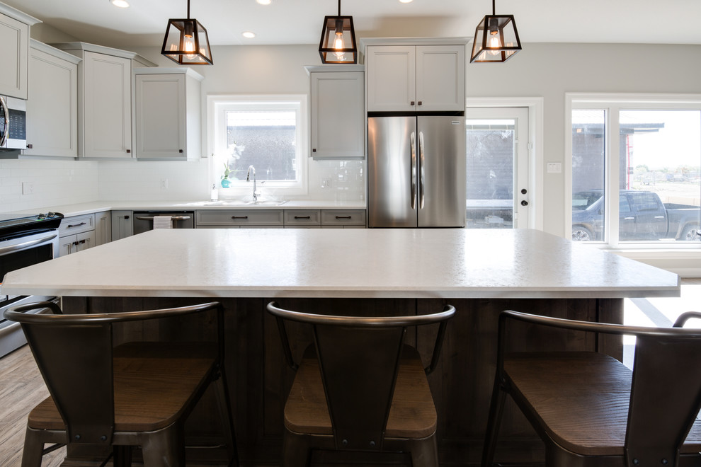 Inspiration for a large transitional l-shaped open concept kitchen remodel with shaker cabinets, gray cabinets, laminate countertops, stainless steel appliances and an island