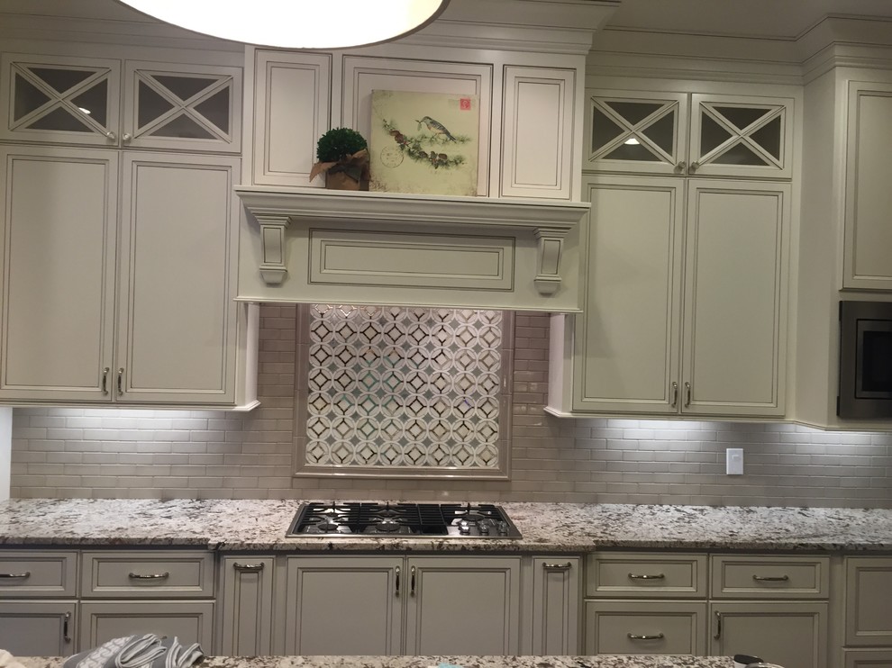 Kitchen - traditional kitchen idea with beaded inset cabinets, beige cabinets, granite countertops, beige backsplash and brick backsplash