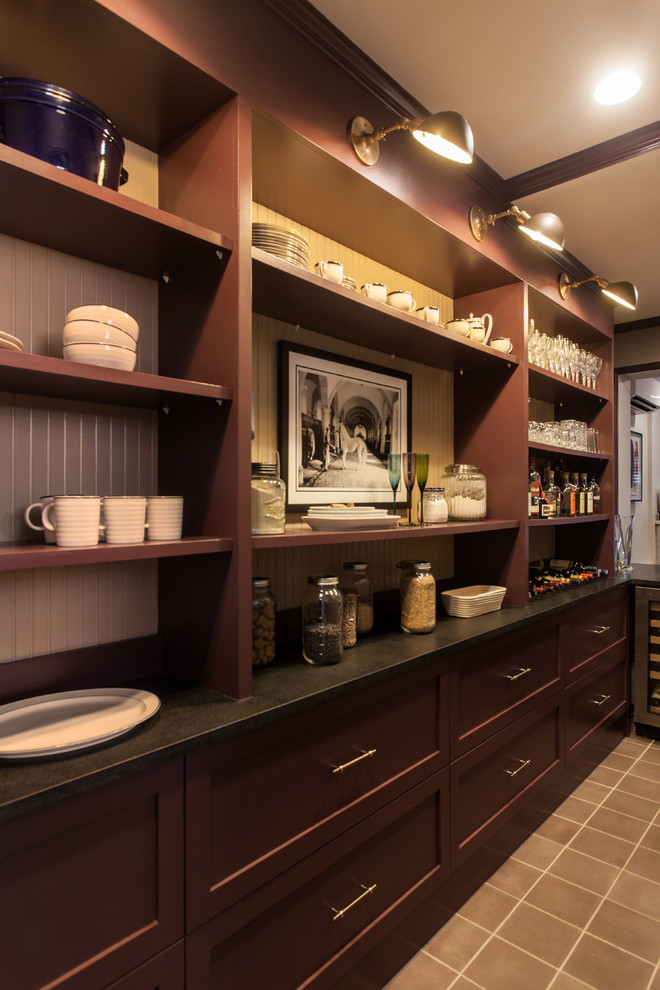 Inspiration for a small transitional galley wet bar in Philadelphia with an undermount sink, flat-panel cabinets, dark wood cabinets, granite benchtops, beige splashback, concrete floors and brown floor.