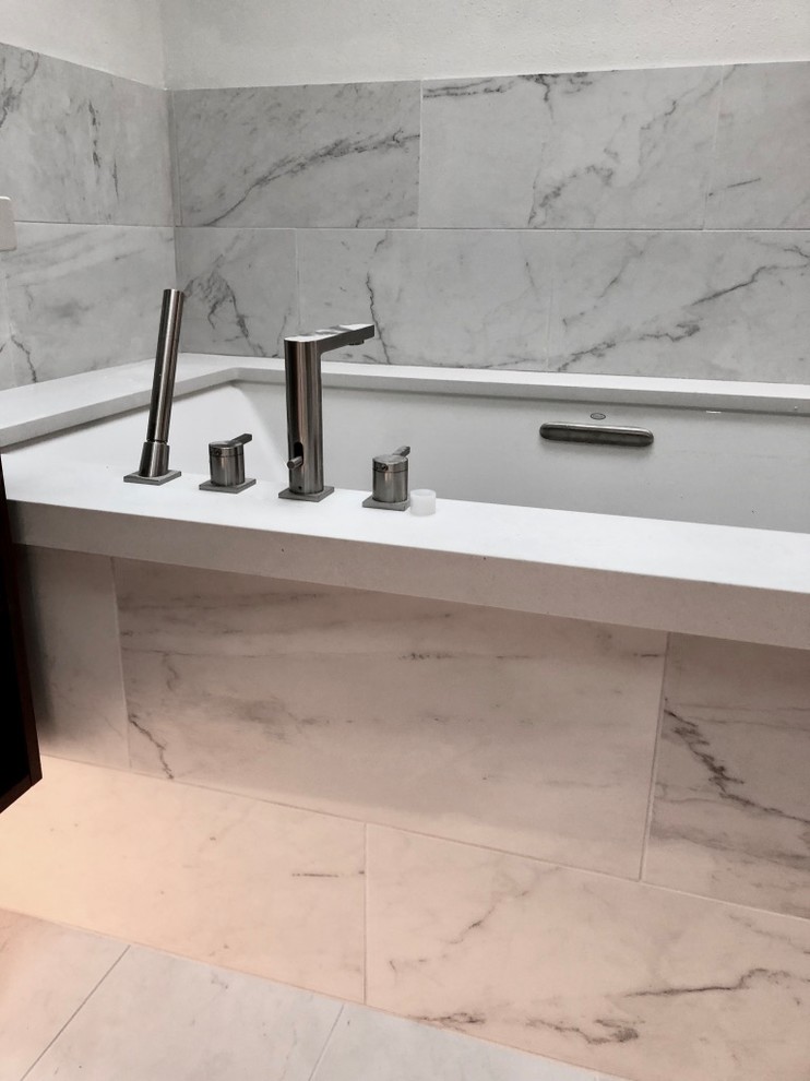Large modern master bathroom in San Francisco with flat-panel cabinets, dark wood cabinets, an undermount tub, a curbless shower, a bidet, white tile, porcelain tile, white walls, porcelain floors, an undermount sink, quartzite benchtops, white floor, a hinged shower door and white benchtops.