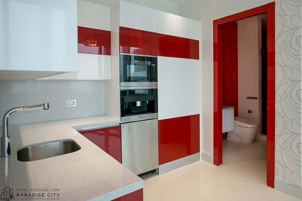 Small contemporary eat-in kitchen in Miami with a single-bowl sink, flat-panel cabinets, red cabinets, granite benchtops, grey splashback, stone slab splashback, ceramic floors and no island.