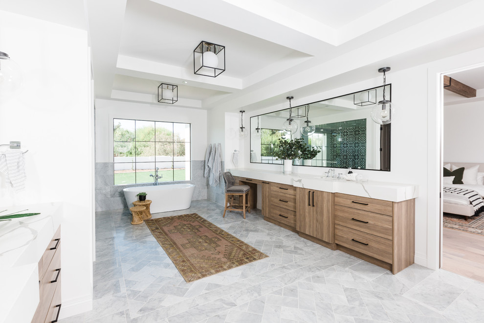 This is an example of a large mediterranean master bathroom in Phoenix with a one-piece toilet, a console sink and grey floor.