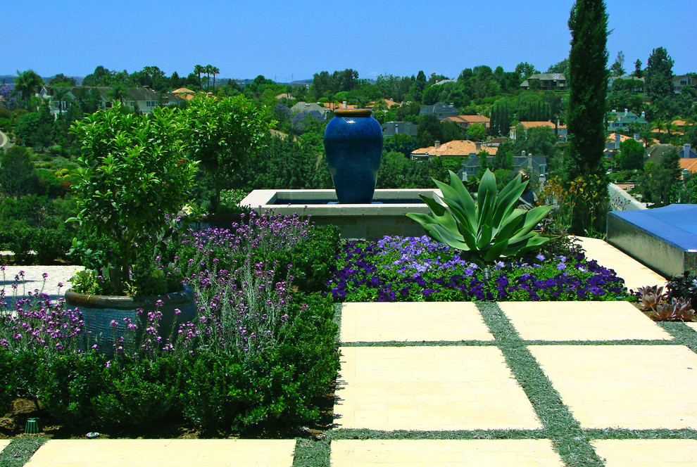 Photo of a mediterranean backyard garden in Orange County with a water feature.