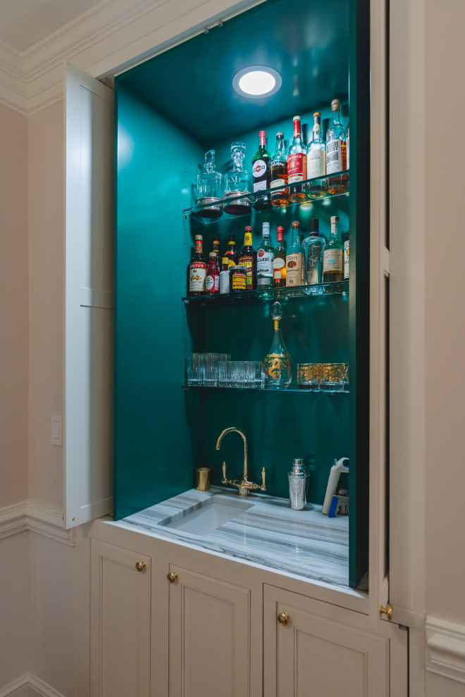 Small transitional home bar in DC Metro with a drop-in sink, marble benchtops, green splashback and multi-coloured benchtop.