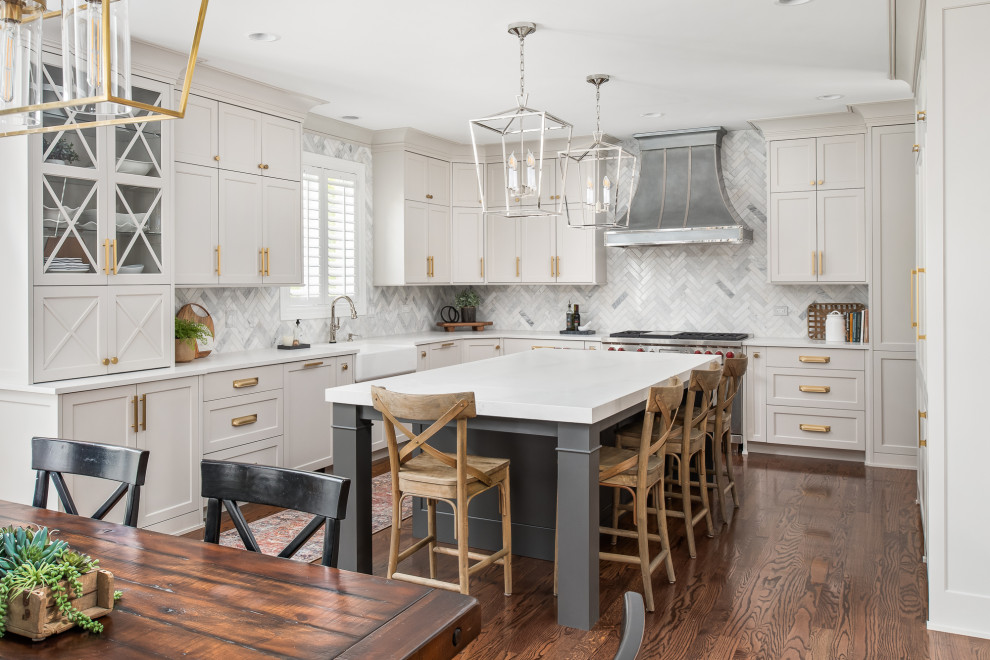 Large transitional u-shaped dark wood floor and brown floor open concept kitchen photo in Chicago with a farmhouse sink, flat-panel cabinets, gray cabinets, quartz countertops, gray backsplash, marble backsplash, stainless steel appliances, an island and white countertops