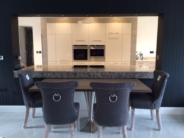 Inspiration for a mid-sized contemporary u-shaped open plan kitchen in West Midlands with flat-panel cabinets, beige cabinets, quartzite benchtops and with island.