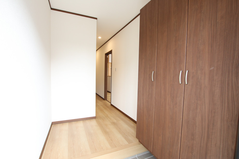 Photo of an asian entryway in Other with plywood floors.