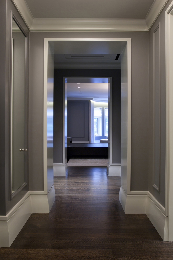 Photo of a mid-sized contemporary hallway in Chicago with grey walls, dark hardwood floors and brown floor.