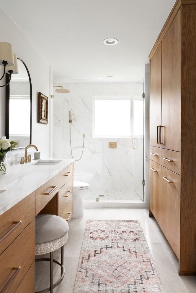 Photo of a medium sized classic ensuite bathroom in Dallas with flat-panel cabinets, light wood cabinets, a built-in shower, a two-piece toilet, white tiles, porcelain tiles, white walls, ceramic flooring, a submerged sink, engineered stone worktops, grey floors, a hinged door, white worktops, a shower bench, double sinks and a built in vanity unit.