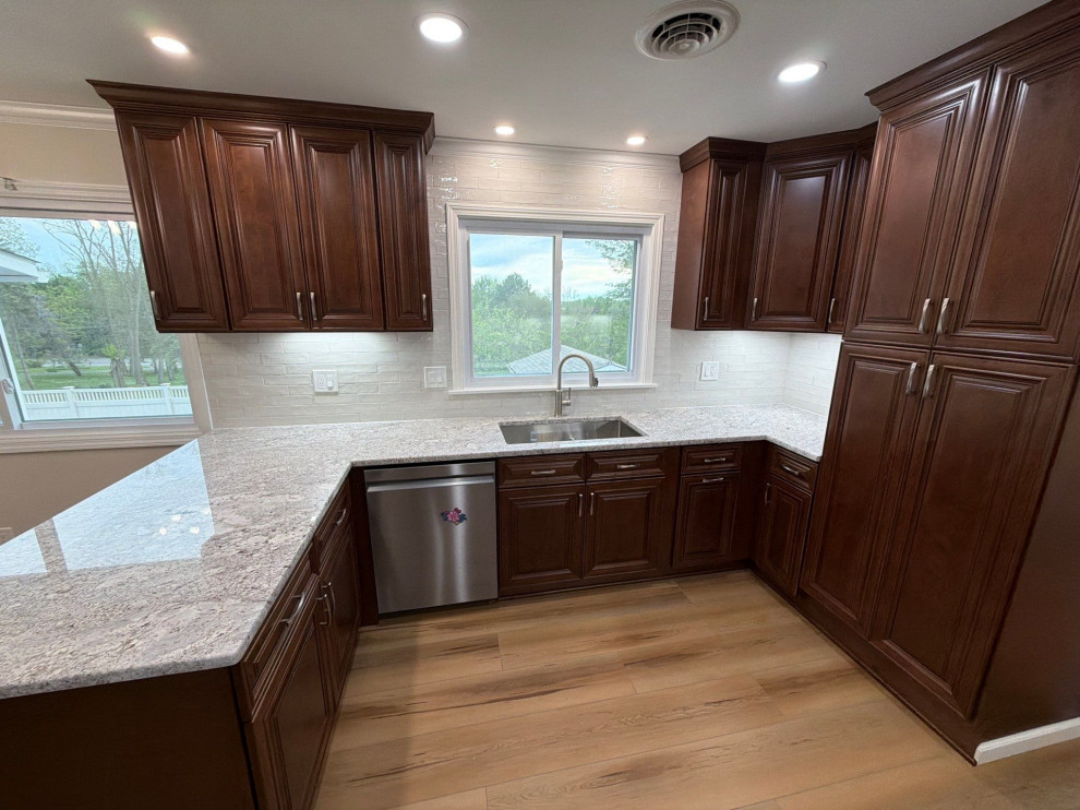 USCD cabinetry accompanied granite countertops, porcelain tile backsplash and Ca