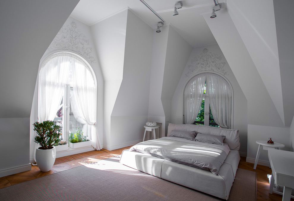 This is an example of a contemporary bedroom in Moscow with white walls, medium hardwood floors and no fireplace.