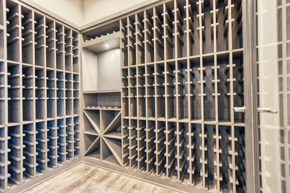 Mid-sized transitional wine cellar in Other with vinyl floors, storage racks and multi-coloured floor.