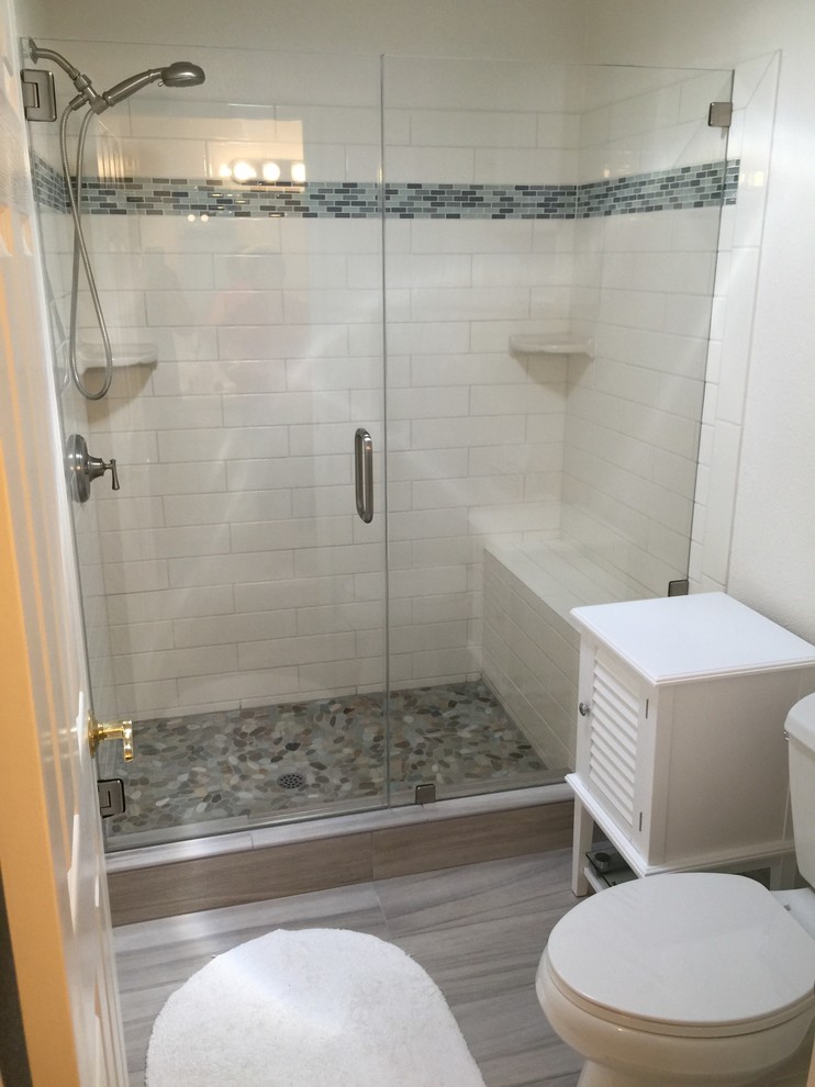 Inspiration for a mid-sized transitional 3/4 bathroom in San Francisco with an alcove shower, a one-piece toilet, white tile, subway tile, white walls and vinyl floors.