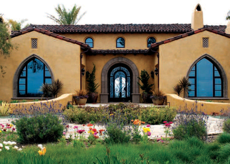 Design ideas for a large mediterranean two-storey stucco house exterior in San Diego with a gable roof and a tile roof.
