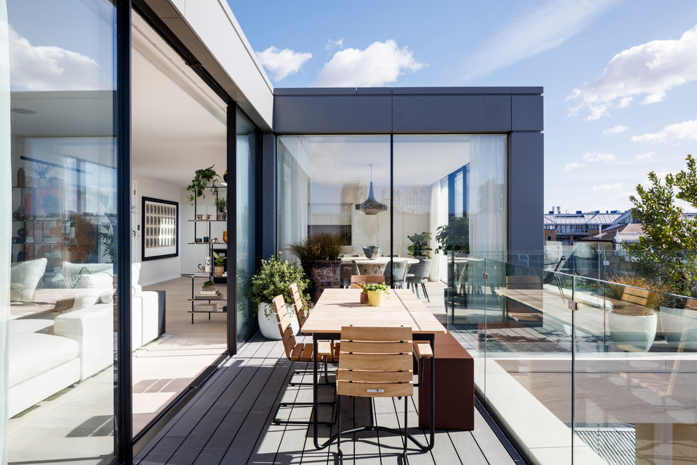 Inspiration for a small contemporary balcony in London with no cover and glass railing.