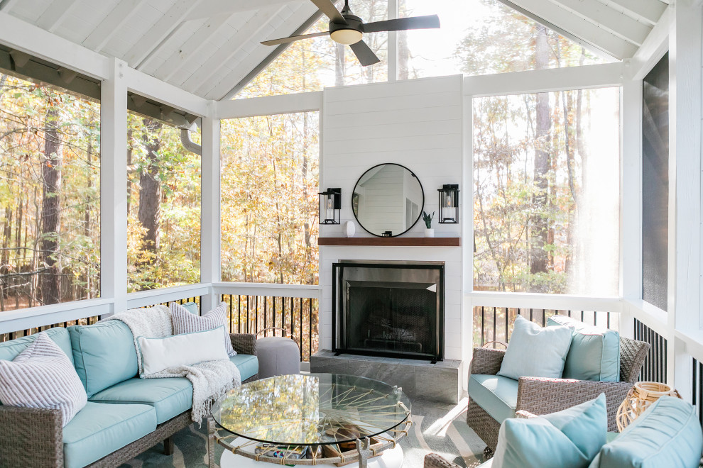 Inspiration for a mid-sized country backyard screened-in verandah in Raleigh with tile and a roof extension.