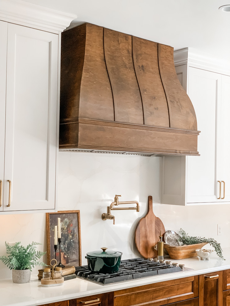 Example of a light wood floor kitchen design with a double-bowl sink, shaker cabinets, white cabinets, quartz countertops, quartz backsplash, paneled appliances and an island