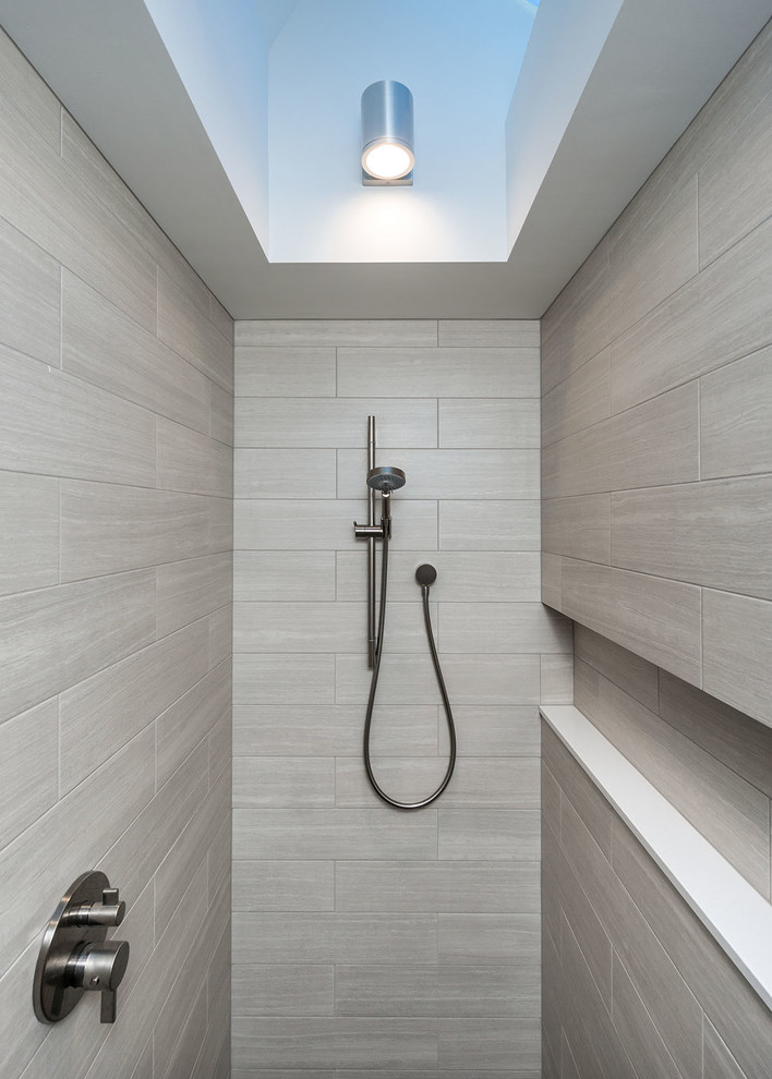 Mid-sized country master bathroom in Portland with an undermount sink, flat-panel cabinets, light wood cabinets, engineered quartz benchtops, a curbless shower, a wall-mount toilet, gray tile, porcelain tile, white walls and porcelain floors.