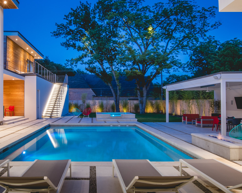 Large contemporary backyard rectangular lap pool in Dallas with a hot tub and concrete slab.