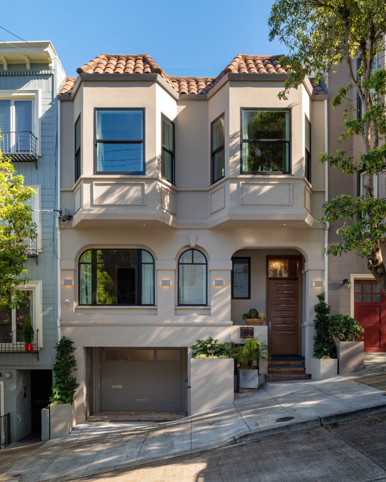 Beige classic detached house in San Francisco with three floors, a tiled roof and a red roof.