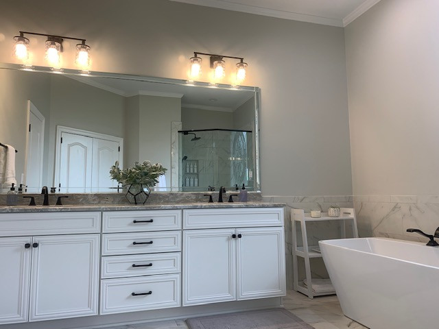 Inspiration for a mid-sized transitional master white tile porcelain tile, white floor and double-sink freestanding bathtub remodel with recessed-panel cabinets, white cabinets, a two-piece toilet, gray walls, an undermount sink, granite countertops, a hinged shower door, beige countertops and a built-in vanity