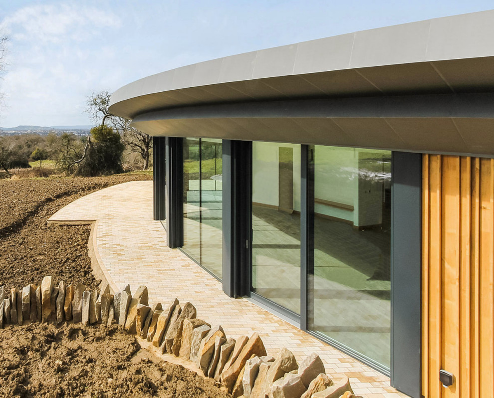 Photo of a large contemporary one-storey exterior in Gloucestershire.