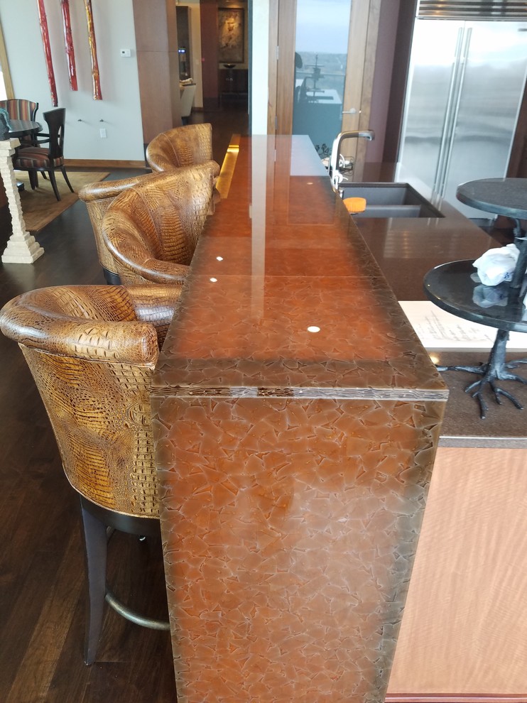 Photo of a mid-sized transitional single-wall home bar in Minneapolis with recycled glass benchtops, glass-front cabinets, medium wood cabinets, grey splashback and mirror splashback.