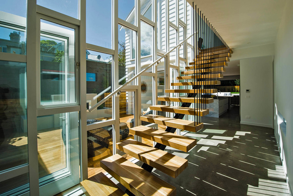 This is an example of a mid-sized contemporary wood straight staircase in Auckland with open risers.