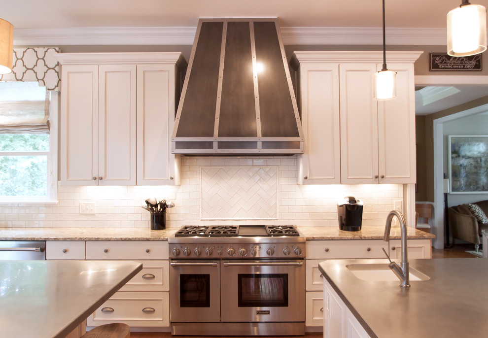 Inspiration for a large transitional medium tone wood floor kitchen remodel in DC Metro with an undermount sink, white cabinets, granite countertops, white backsplash, ceramic backsplash and stainless steel appliances