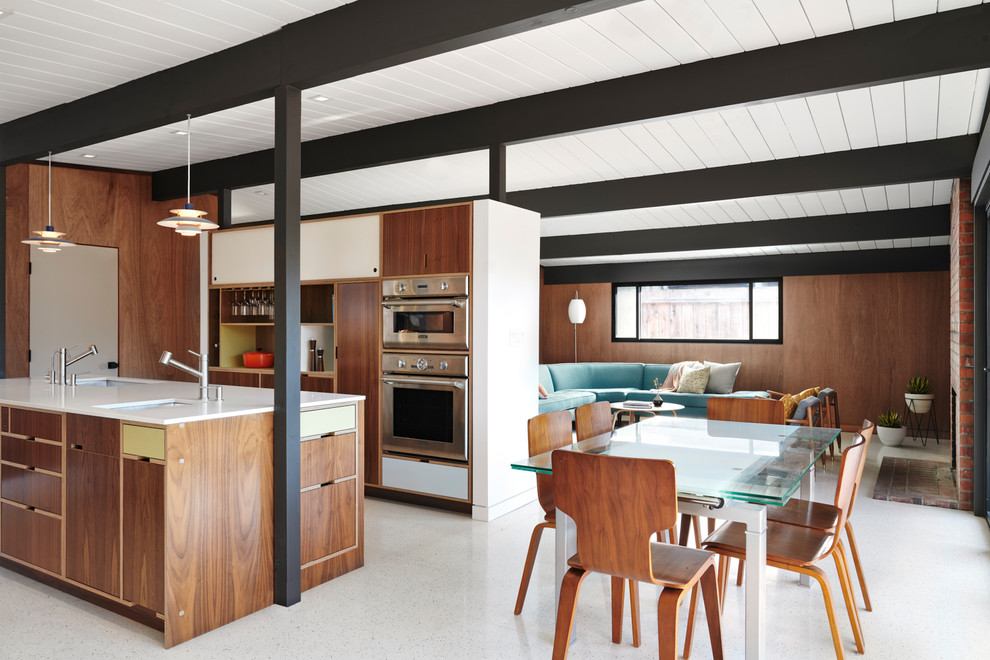 Photo of a midcentury open plan dining in San Francisco with brown walls and white floor.