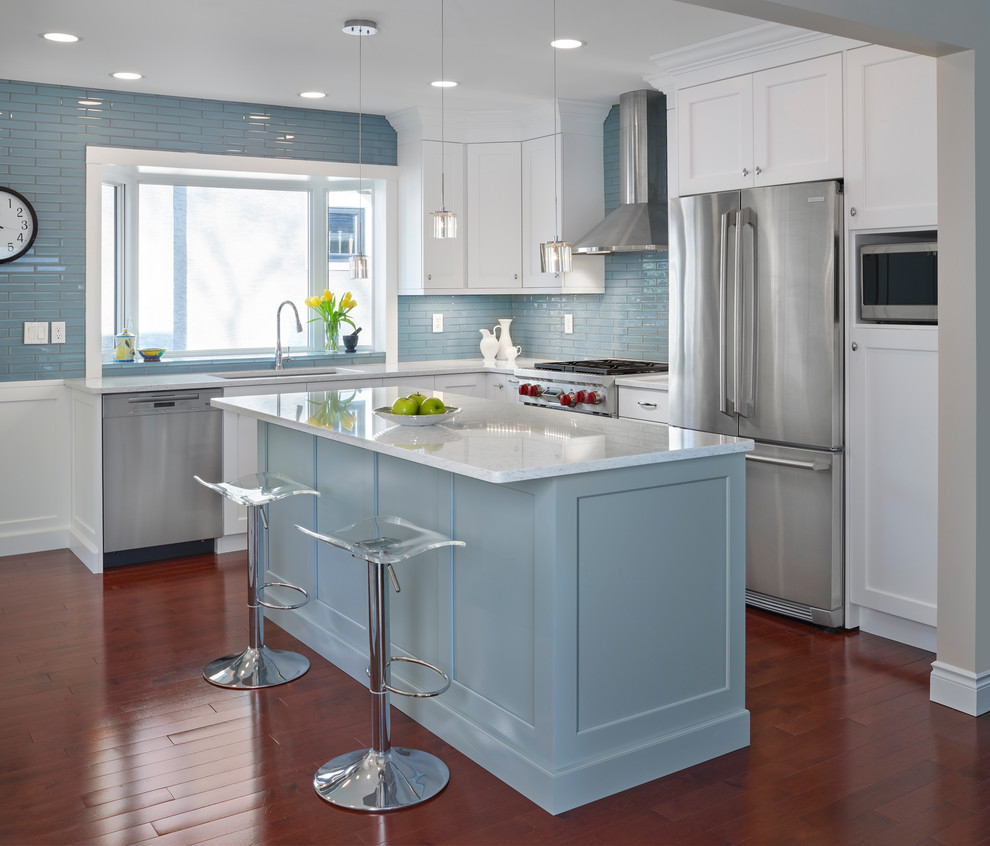 Mid-sized transitional l-shaped medium tone wood floor and orange floor kitchen photo in Edmonton with an undermount sink, white cabinets, quartz countertops, blue backsplash, stainless steel appliances, an island, shaker cabinets and glass tile backsplash