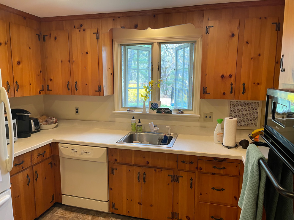 Example of a small transitional u-shaped slate floor and brown floor enclosed kitchen design in Boston with an undermount sink, shaker cabinets, white cabinets, quartz countertops, stainless steel appliances, no island and white countertops