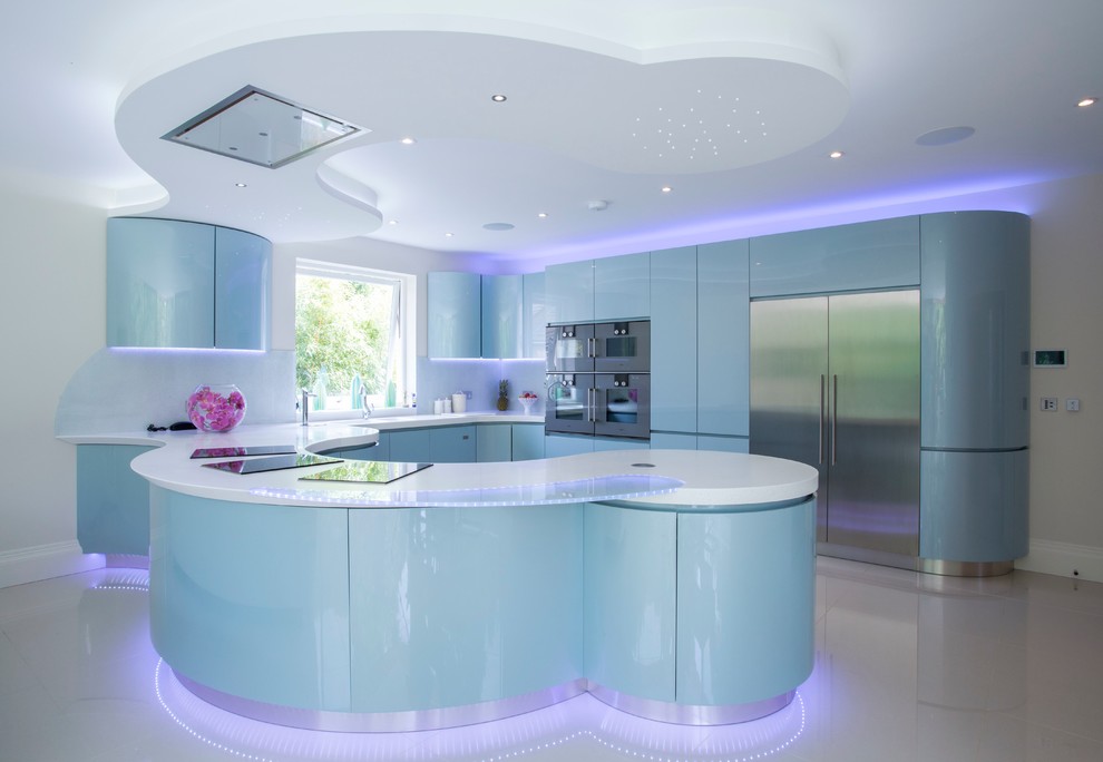 Design ideas for an expansive contemporary l-shaped open plan kitchen in London with an integrated sink, flat-panel cabinets, blue cabinets, solid surface benchtops, grey splashback, glass sheet splashback, stainless steel appliances, porcelain floors and a peninsula.