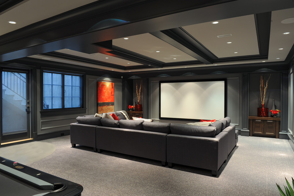 Inspiration for a transitional open concept home theatre in Vancouver with grey walls, carpet, a projector screen and beige floor.