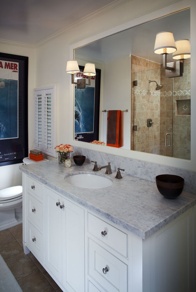 This is an example of a small traditional master bathroom in Los Angeles with marble benchtops, an undermount sink, recessed-panel cabinets, white cabinets, an open shower, stone slab, white walls and porcelain floors.