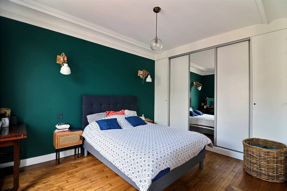 Photo of a large contemporary master bedroom in Paris with green walls, dark hardwood floors and brown floor.