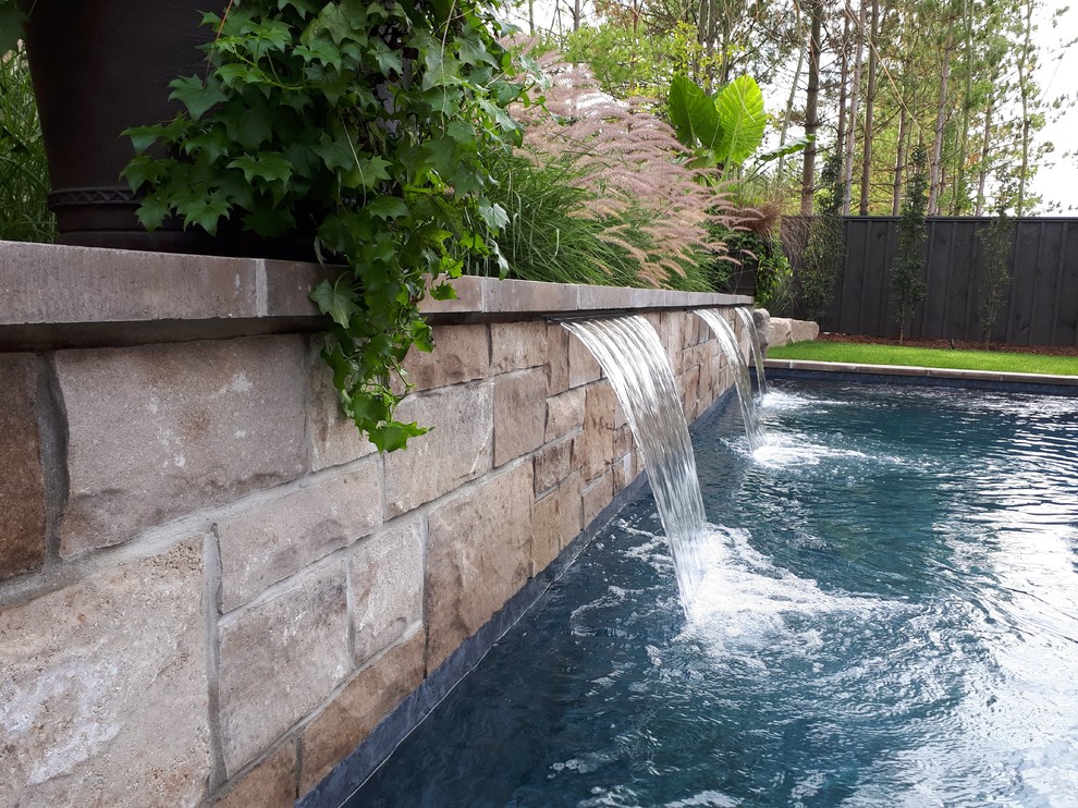 Inspiration for a small transitional backyard concrete paver and rectangular pool fountain remodel