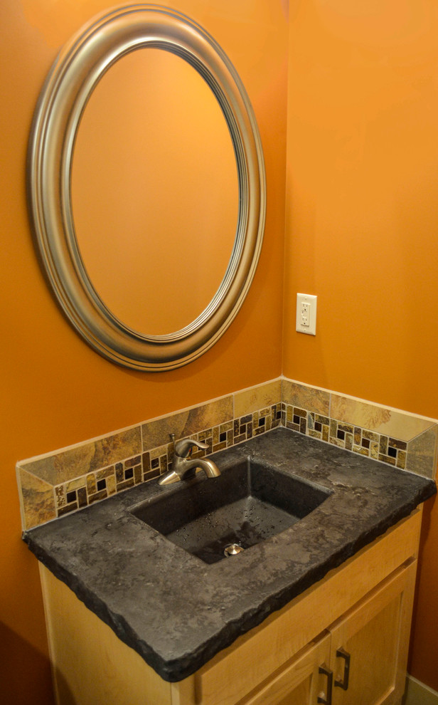 Inspiration for a mid-sized modern 3/4 bathroom in Kansas City with an integrated sink, shaker cabinets, light wood cabinets, concrete benchtops, multi-coloured tile, cement tile, orange walls and concrete floors.