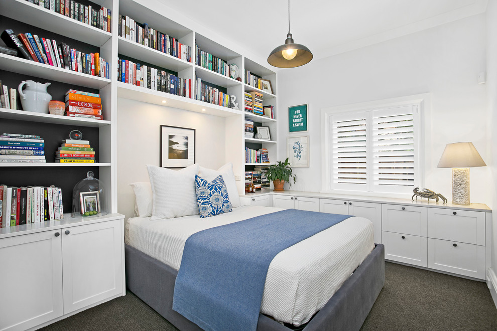 This is an example of a small transitional guest bedroom in Sydney with white walls and carpet.