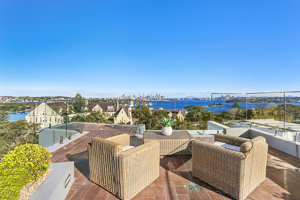This is an example of a mid-sized contemporary rooftop deck in Sydney with no cover.