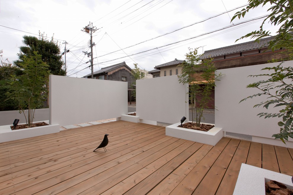 Photo of an asian side yard deck in Other with no cover.