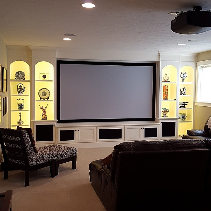 Inspiration for a large arts and crafts open concept home theatre in Other with a projector screen, brown walls and carpet.