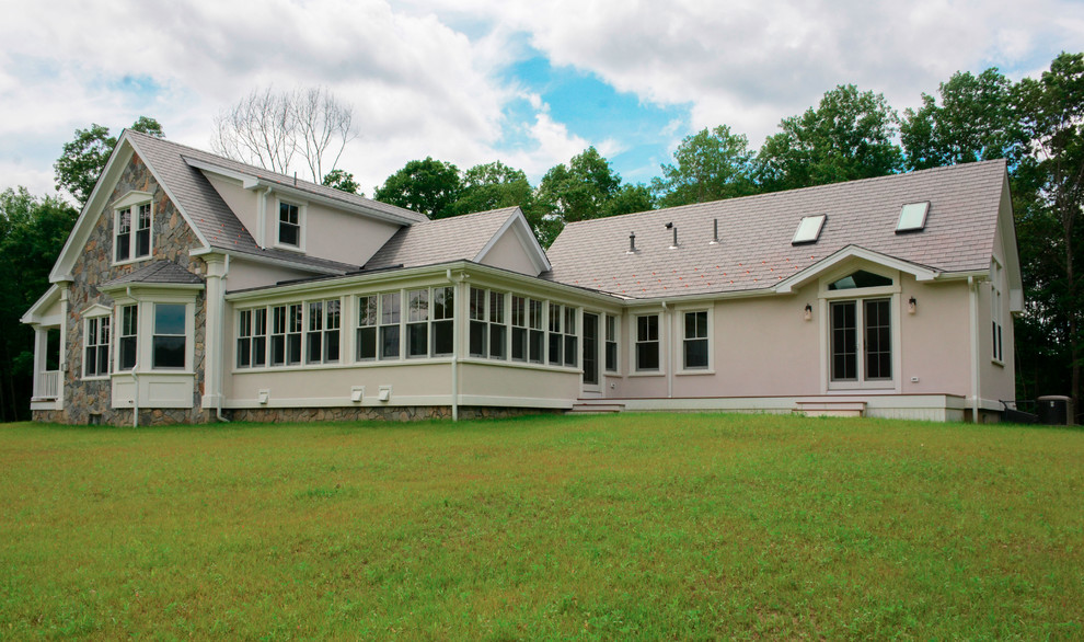 Large traditional two floor house exterior in Boston with mixed cladding and a pitched roof.