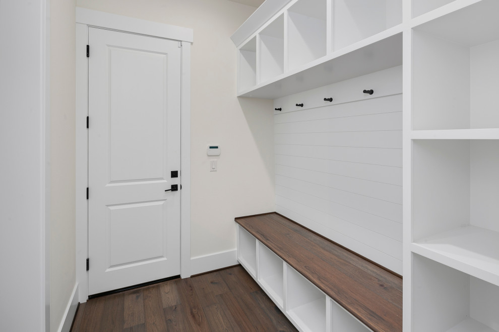 Design ideas for a large country mudroom in Seattle with white walls, dark hardwood floors, a single front door, a white front door and brown floor.
