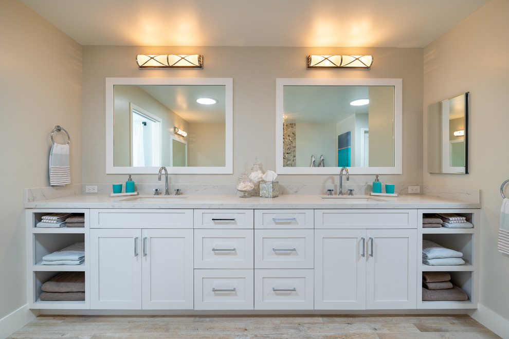 Design ideas for an expansive transitional master bathroom in Los Angeles with shaker cabinets, white cabinets, a freestanding tub, an alcove shower, a wall-mount toilet, porcelain tile, porcelain floors, a drop-in sink, quartzite benchtops and white benchtops.
