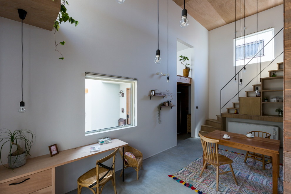 This is an example of a mid-sized asian kitchen/dining combo in Kyoto with white walls, concrete floors and grey floor.