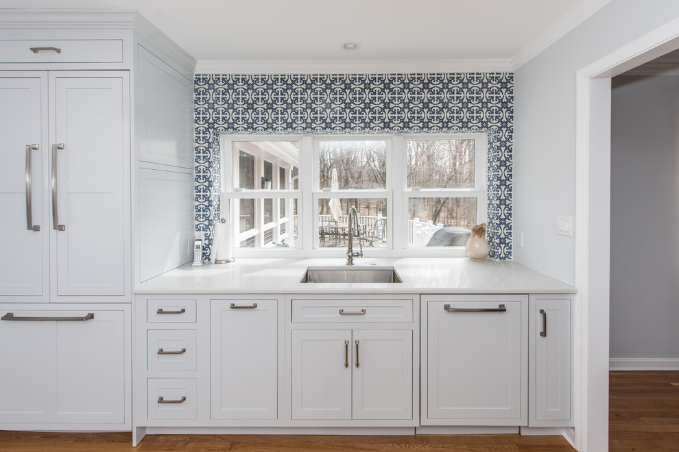Inspiration for a mid-sized traditional u-shaped open plan kitchen in DC Metro with an undermount sink, beaded inset cabinets, grey cabinets, marble benchtops, multi-coloured splashback, ceramic splashback, stainless steel appliances, light hardwood floors, with island, brown floor and grey benchtop.